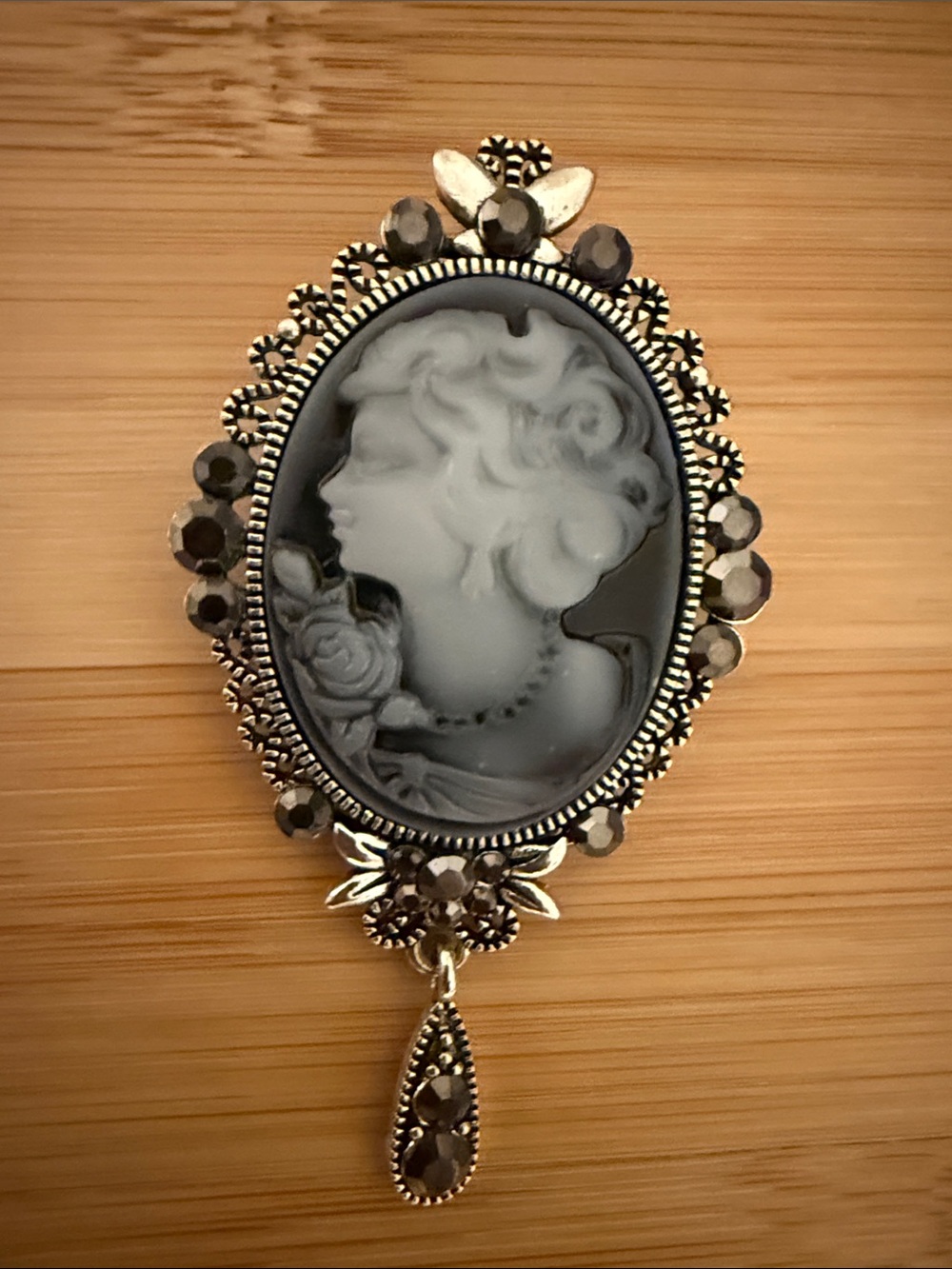 Ornate Silver-Tone Cameo Brooch with Teardrop Dangle